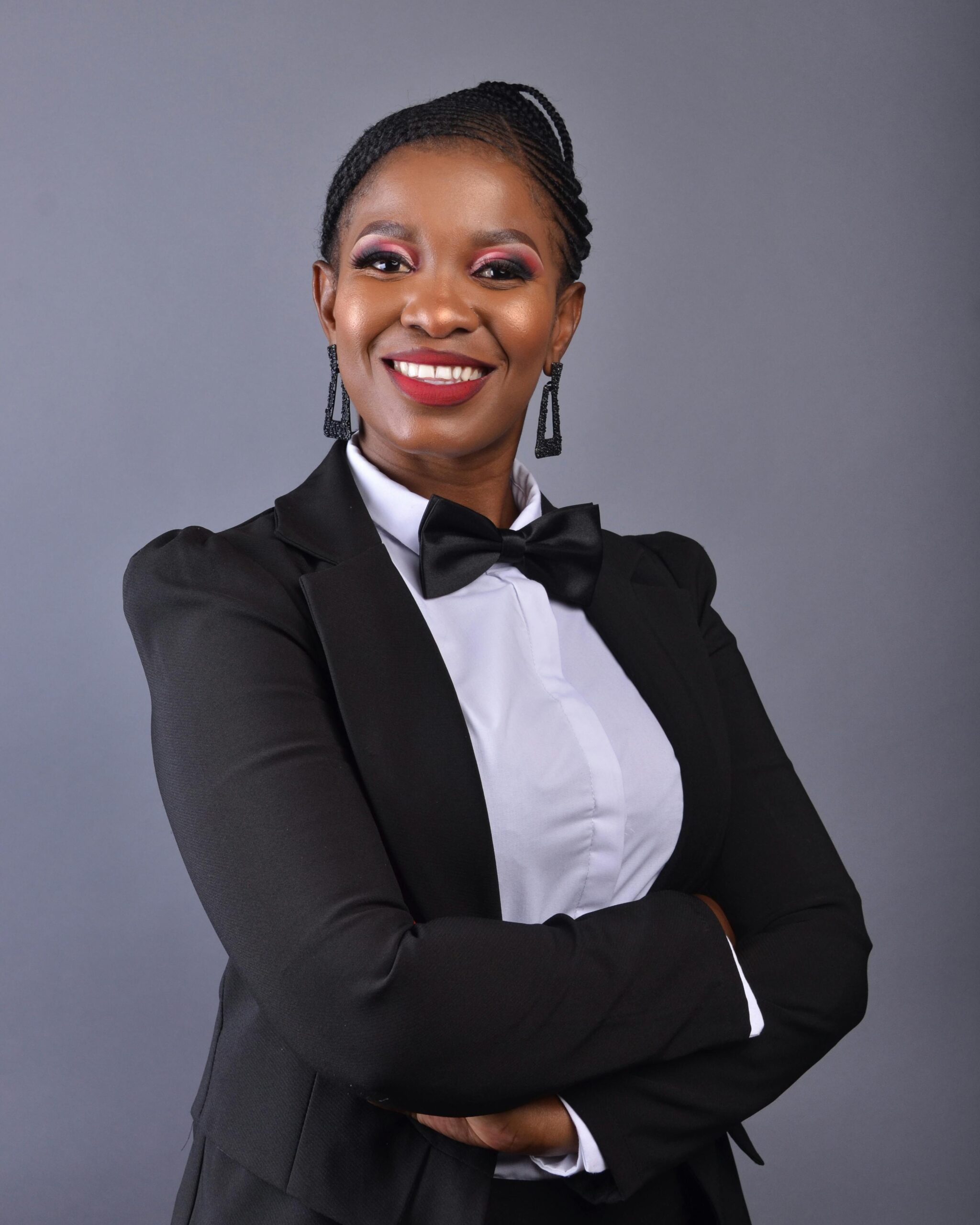 Portrait of a smiling African businesswoman in formal attire, showcasing professionalism and confidence.